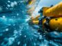 Close-up image of specialized equipment lowering a section of electric power cable into the sea
